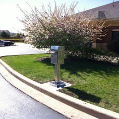 Drop Box in Front of a Flowering Bush Located at 5000 Sleepy Hollow Road