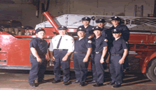 Group of Firefighters in Front of Ladder Truck
